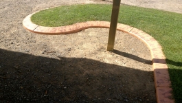 Concrete garden edging can curve around obstacles